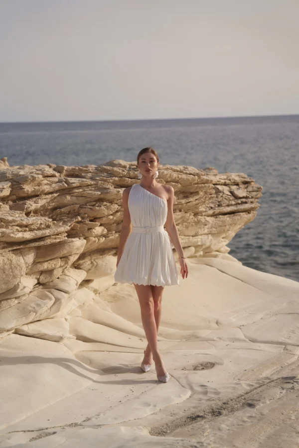 Pleated mini dress for wedding guest celebrations by REPULO’S