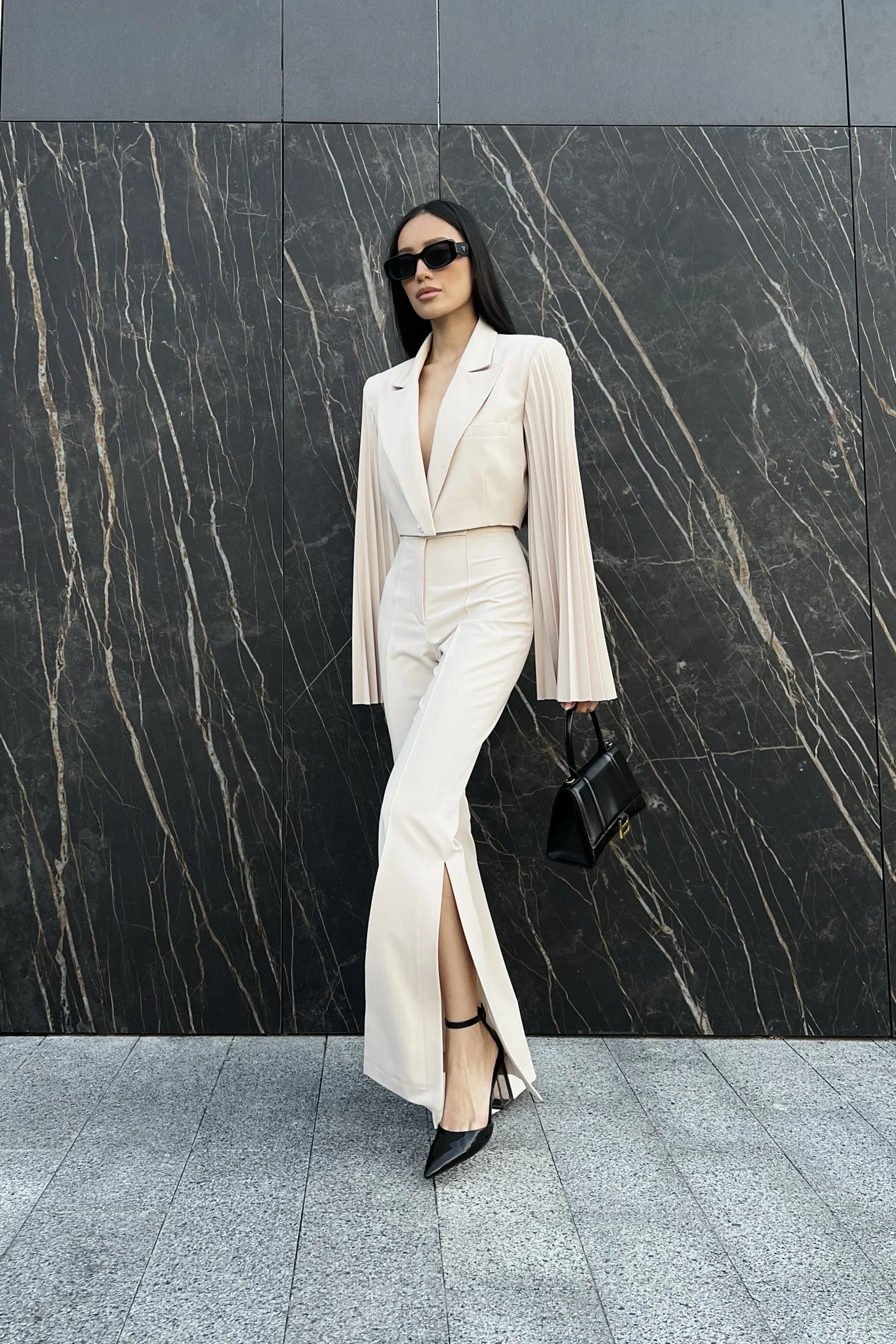 Elegant beige flared pants with dramatic side slits by REPULO’S