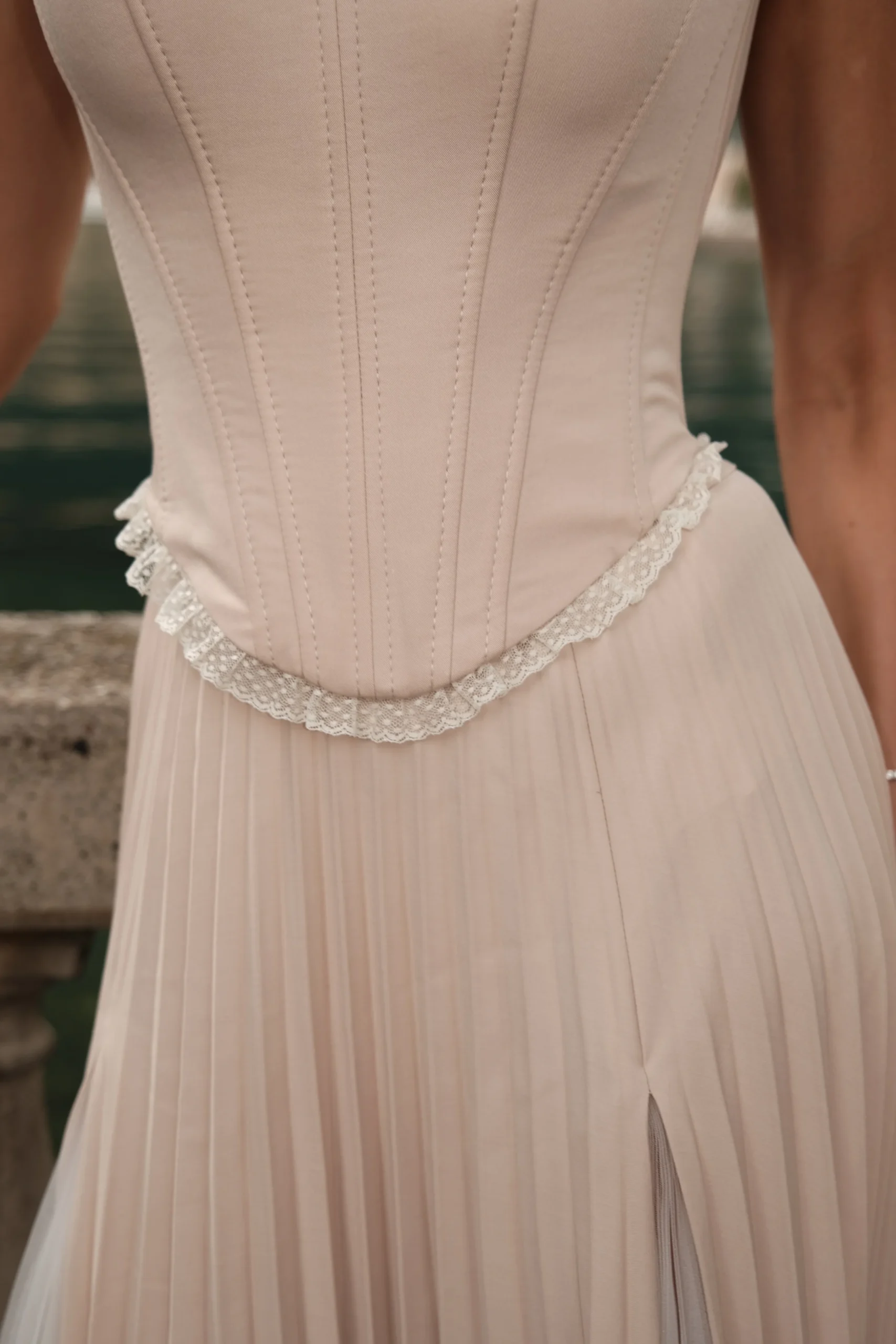 Elegant beige corset top with soft lace accents for resort and vacation styling by REPULO’S