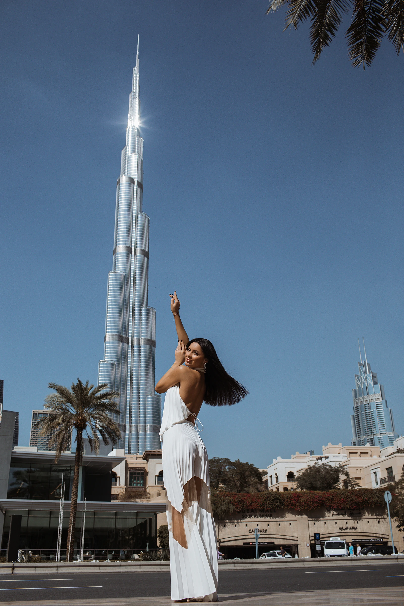 Wide-leg pleated trousers in ivory plissé worn with a halter top for a Dubai evening by REPULO'S