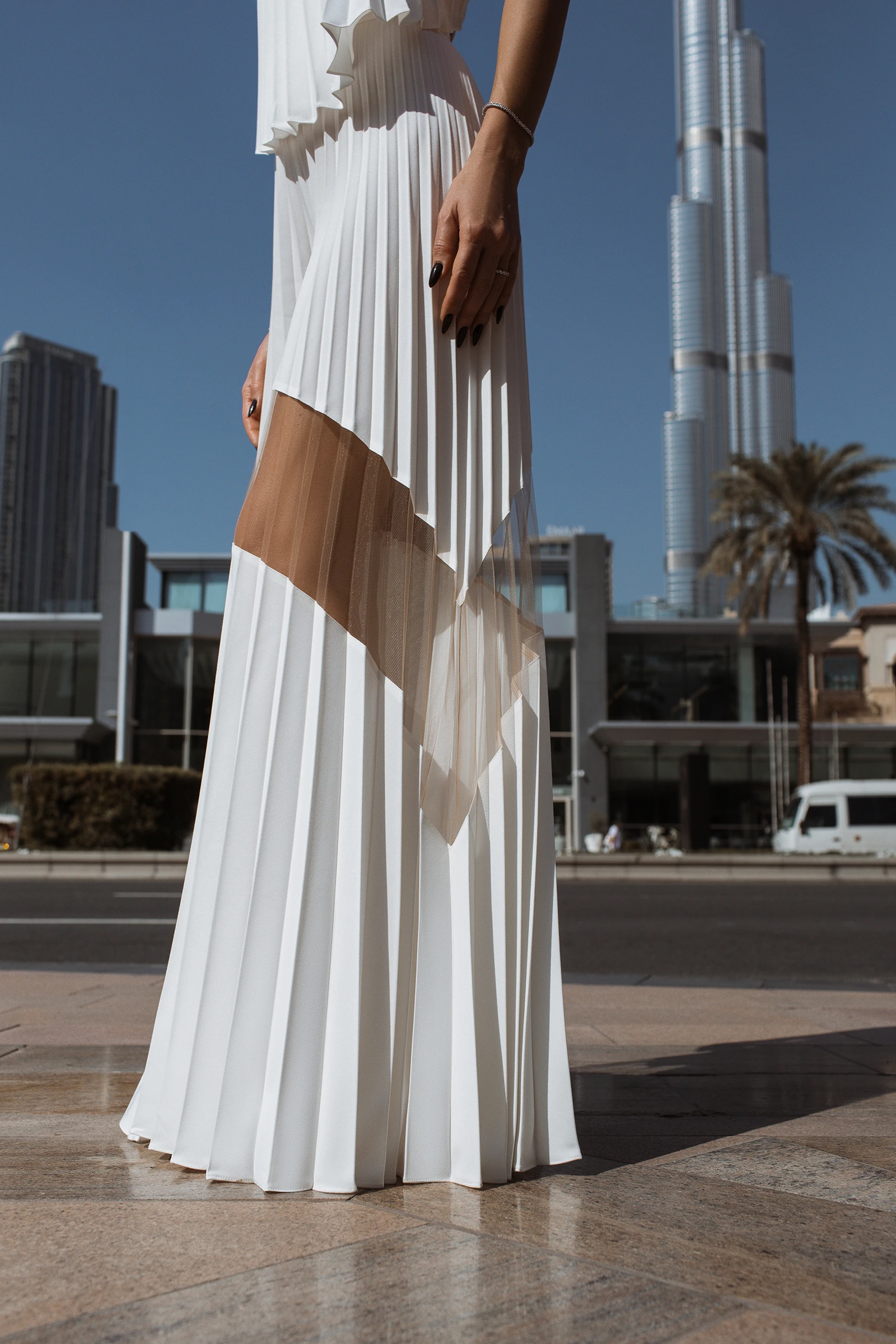 Pleated wide-leg pants with sheer mesh panels styled with a backless halter top by REPULO'S