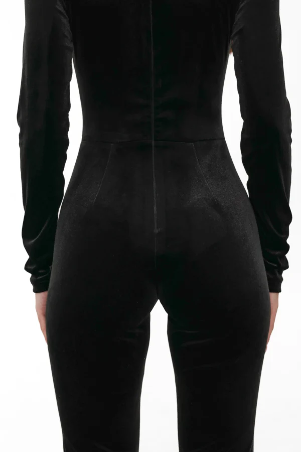 Close-up of the fitted cut of the velvet jumpsuit from the back