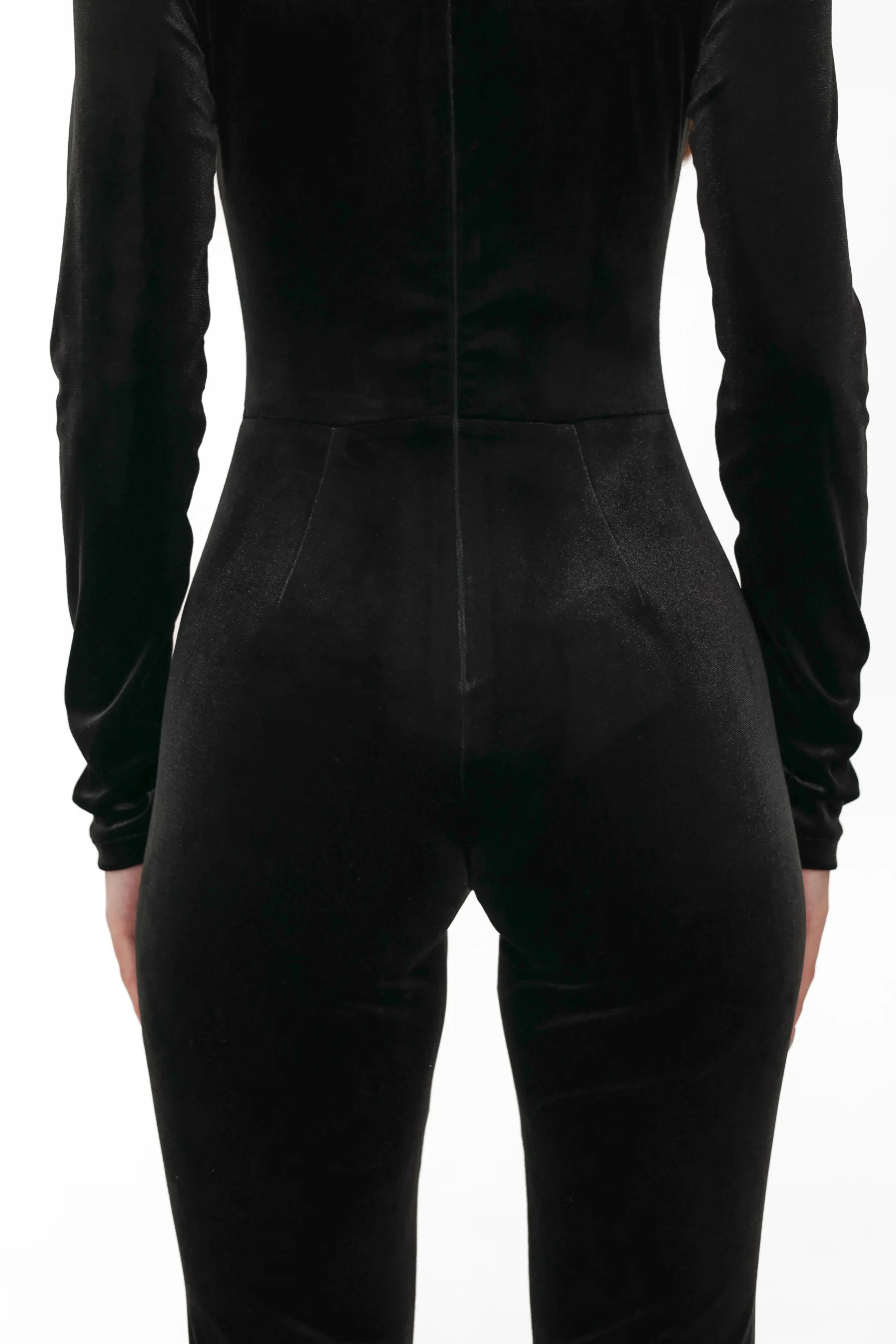 Close-up of the fitted cut of the velvet jumpsuit from the back