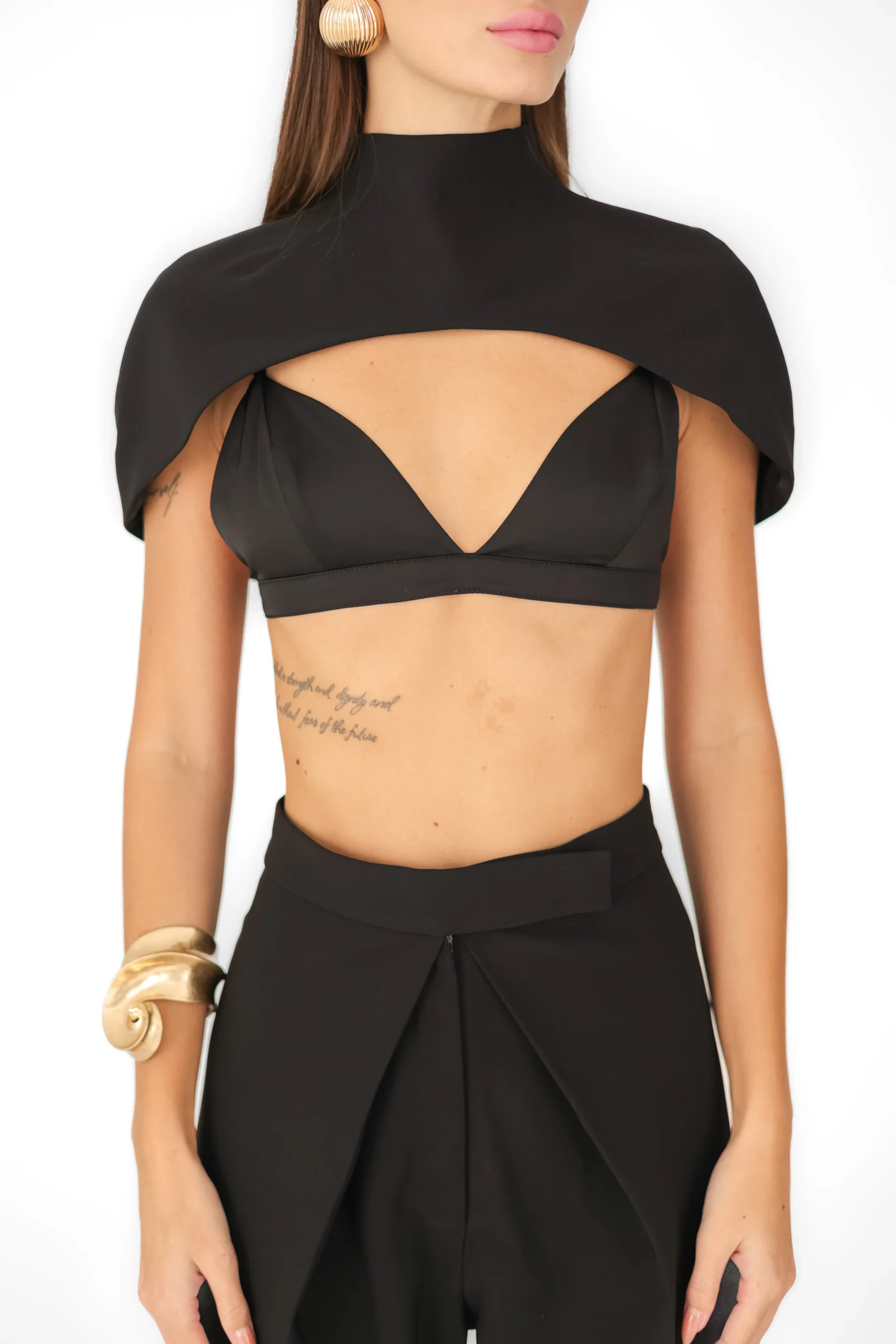 Close-up of the high turtleneck and structured shoulders of the Aurora cape