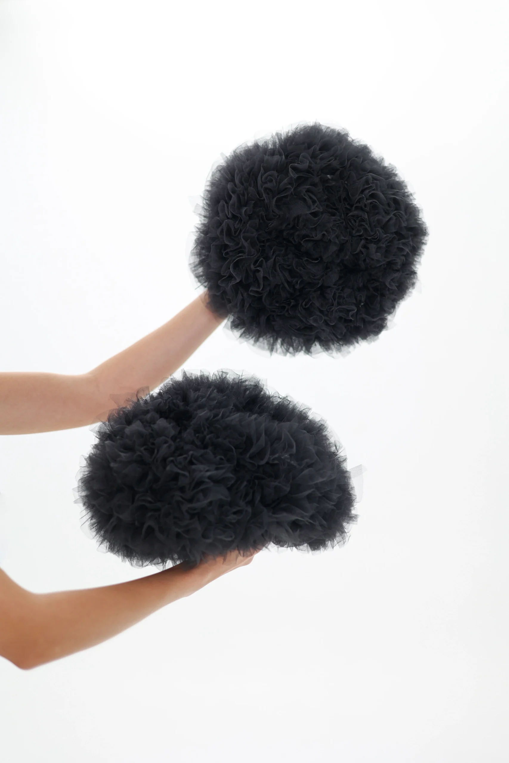 Black detachable tulle sleeves held in hand