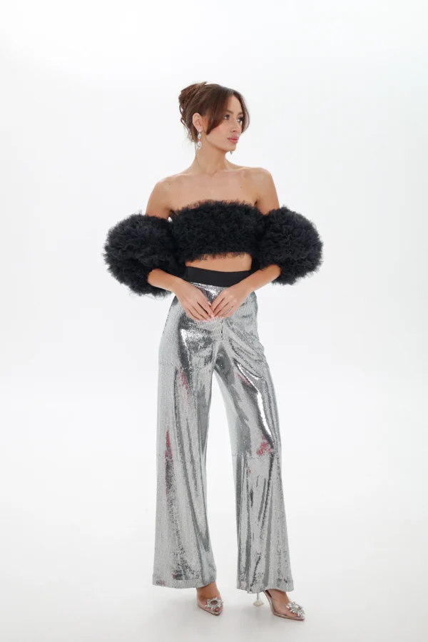 Model wearing the black Cloud top with detachable sleeves, full-length look