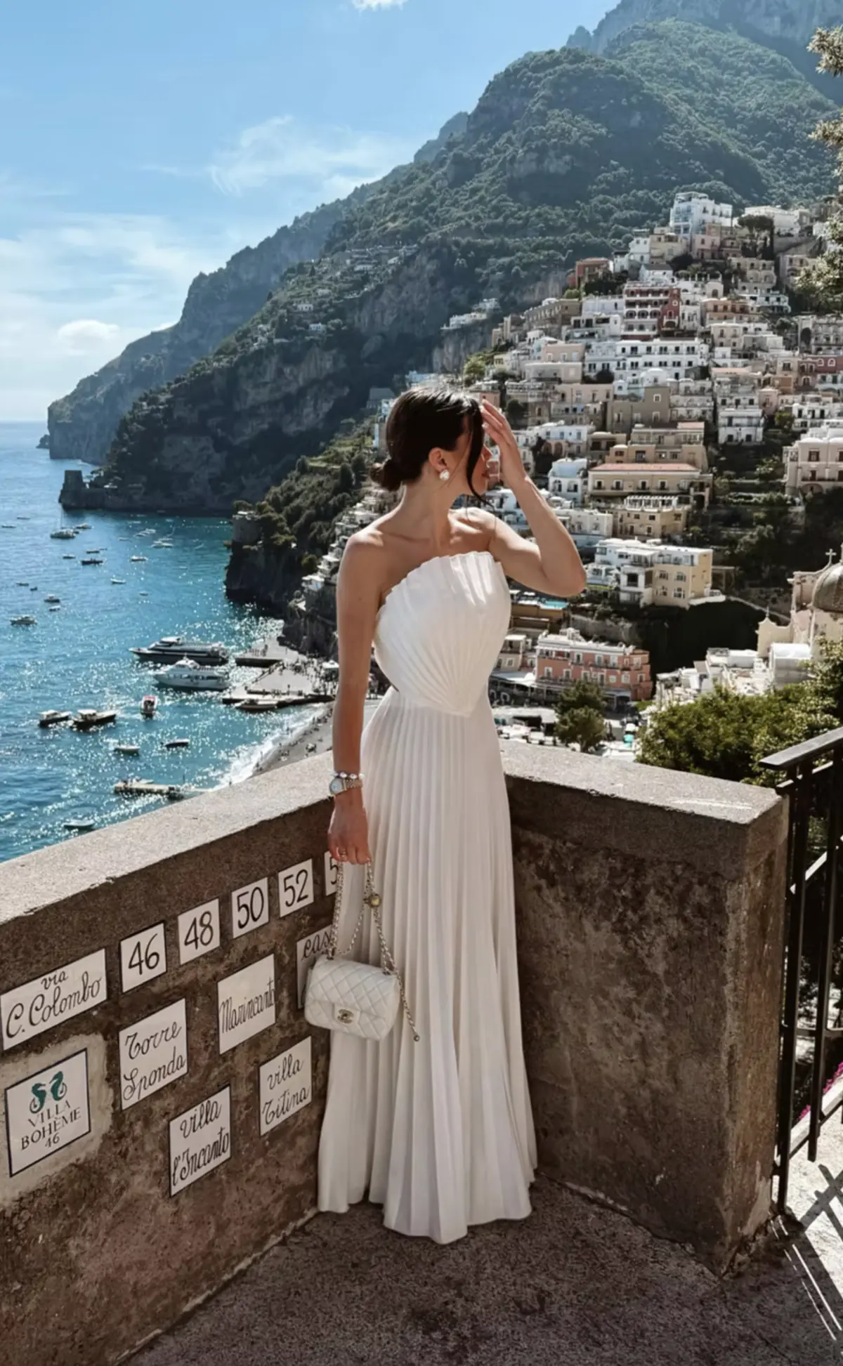 Pleated summer evening dress Shell by REPULO'S in white against the Positano coastline