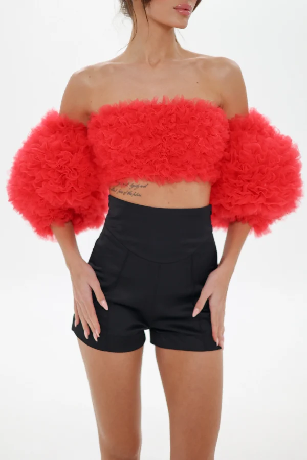Red corset bandeau top with puff sleeves and tailored black shorts