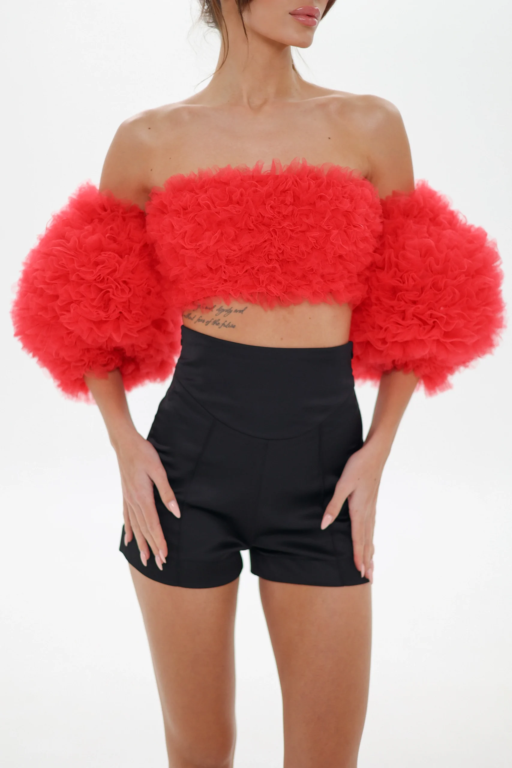 Red corset bandeau top with puff sleeves and tailored black shorts
