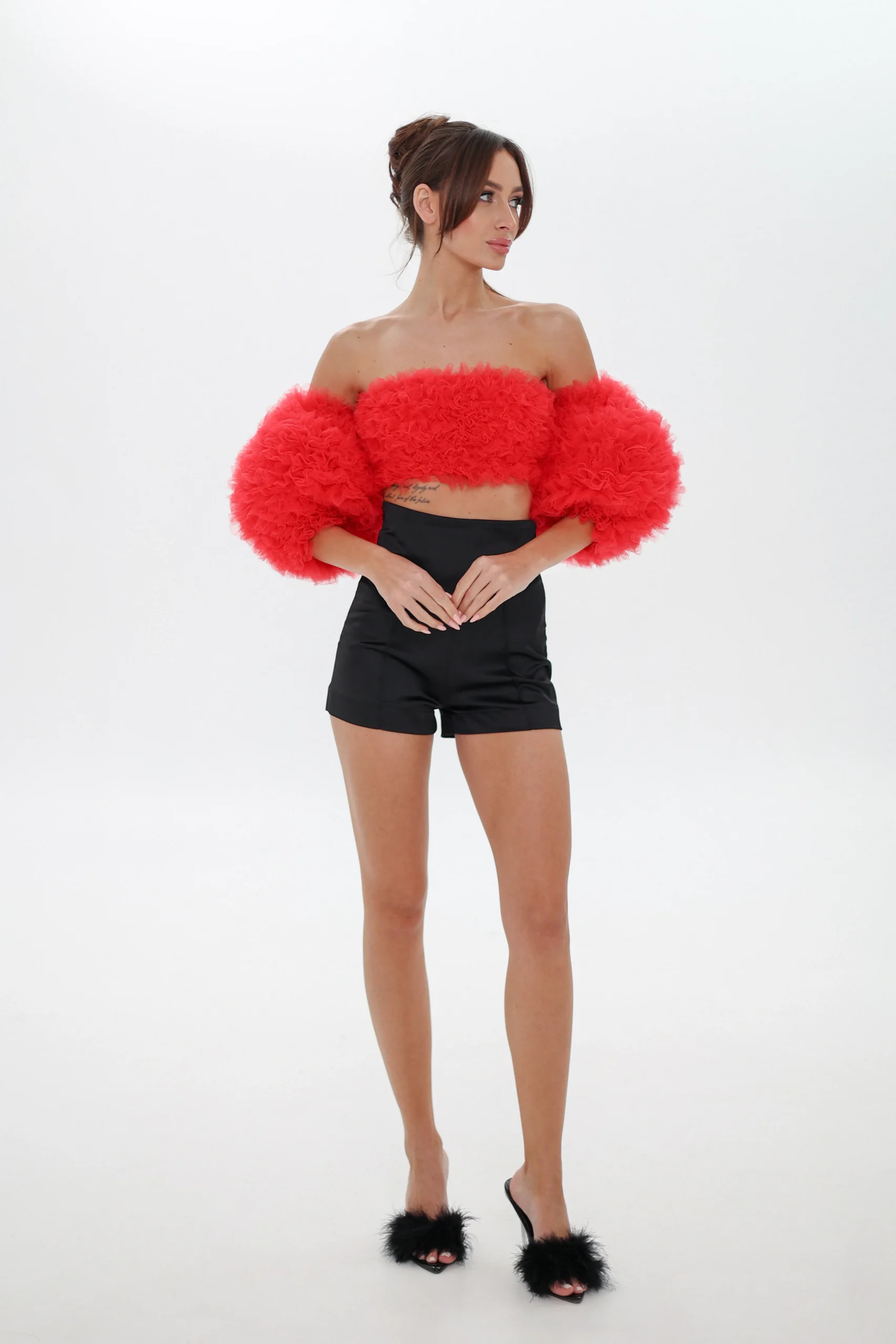Model wearing the red Cloud top with detachable puff sleeves