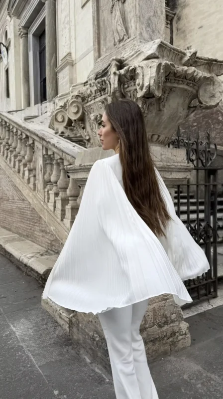 Roman Holidays look by REPULO'S: white pleated sleeve wrap blouse and flared trousers on a Roman street