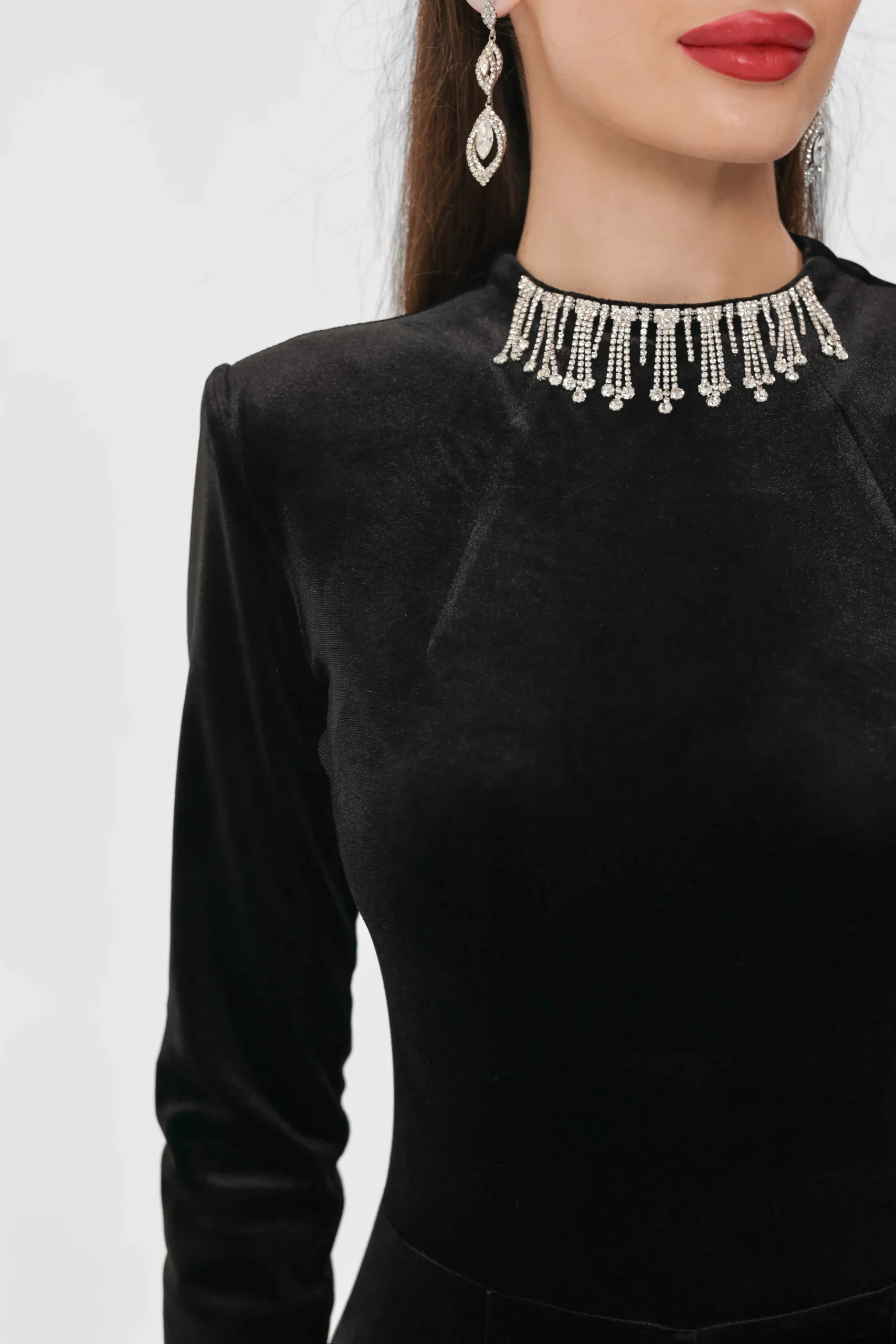 Close-up of the crystal fringe and the structured shoulders of the jumpsuit