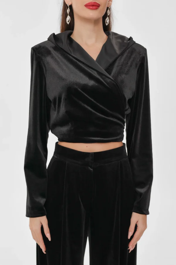 Close-up of the wrap front on the REPULO’S velvet wrap top, hood down and cropped hem