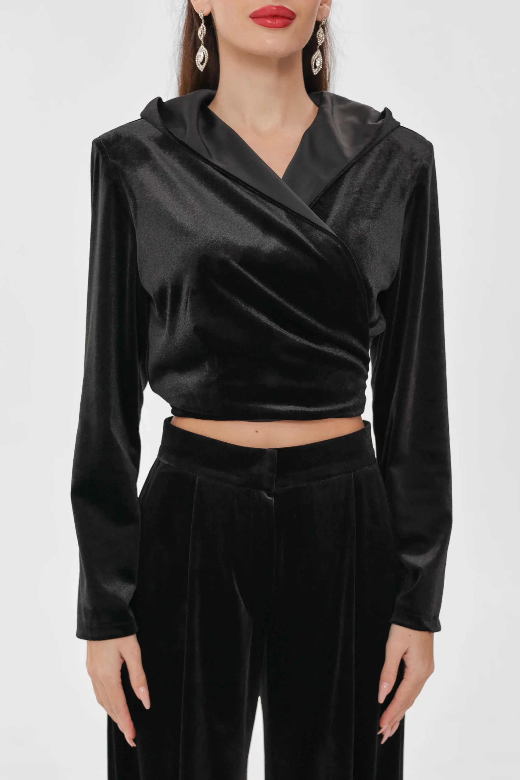 Close-up of the wrap front on the REPULO’S velvet wrap top, hood down and cropped hem