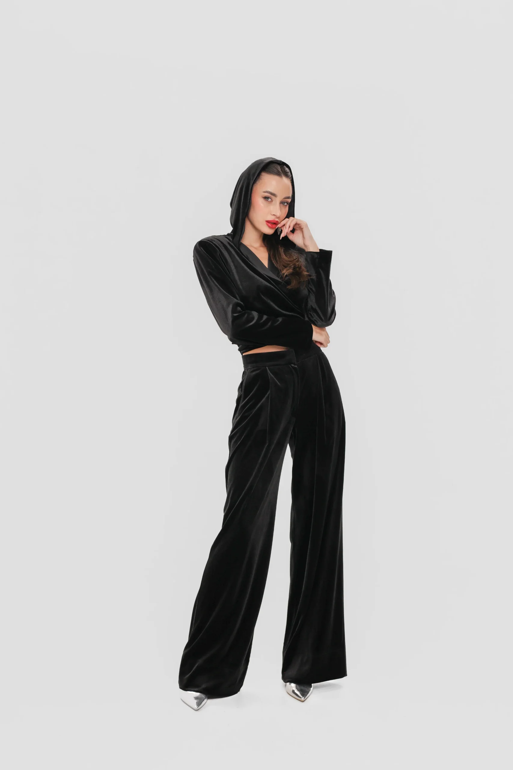 Side view of the elegant velvet wrap top with hood and structured shoulders
