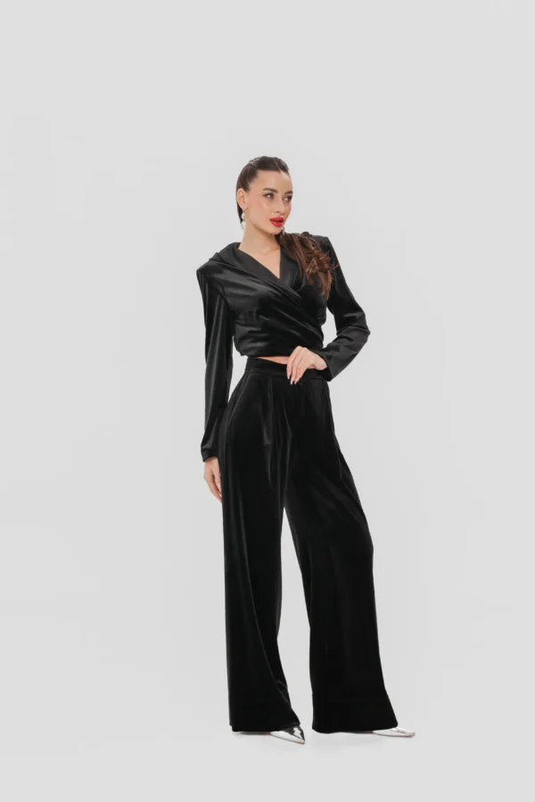 Black velvet set with a cropped wrap top and palazzo trousers by REPULO’S