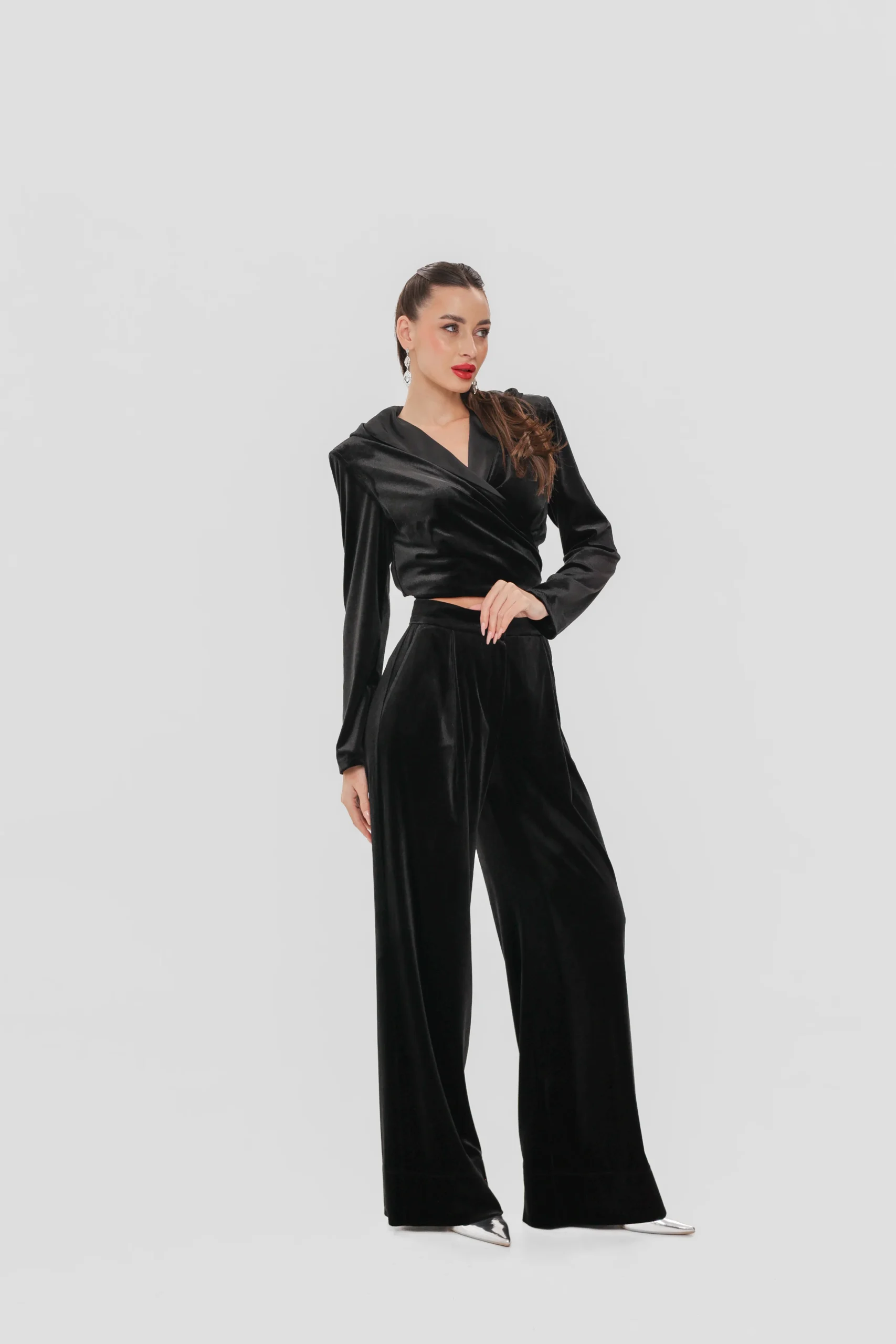Black velvet set with a cropped wrap top and palazzo trousers by REPULO’S
