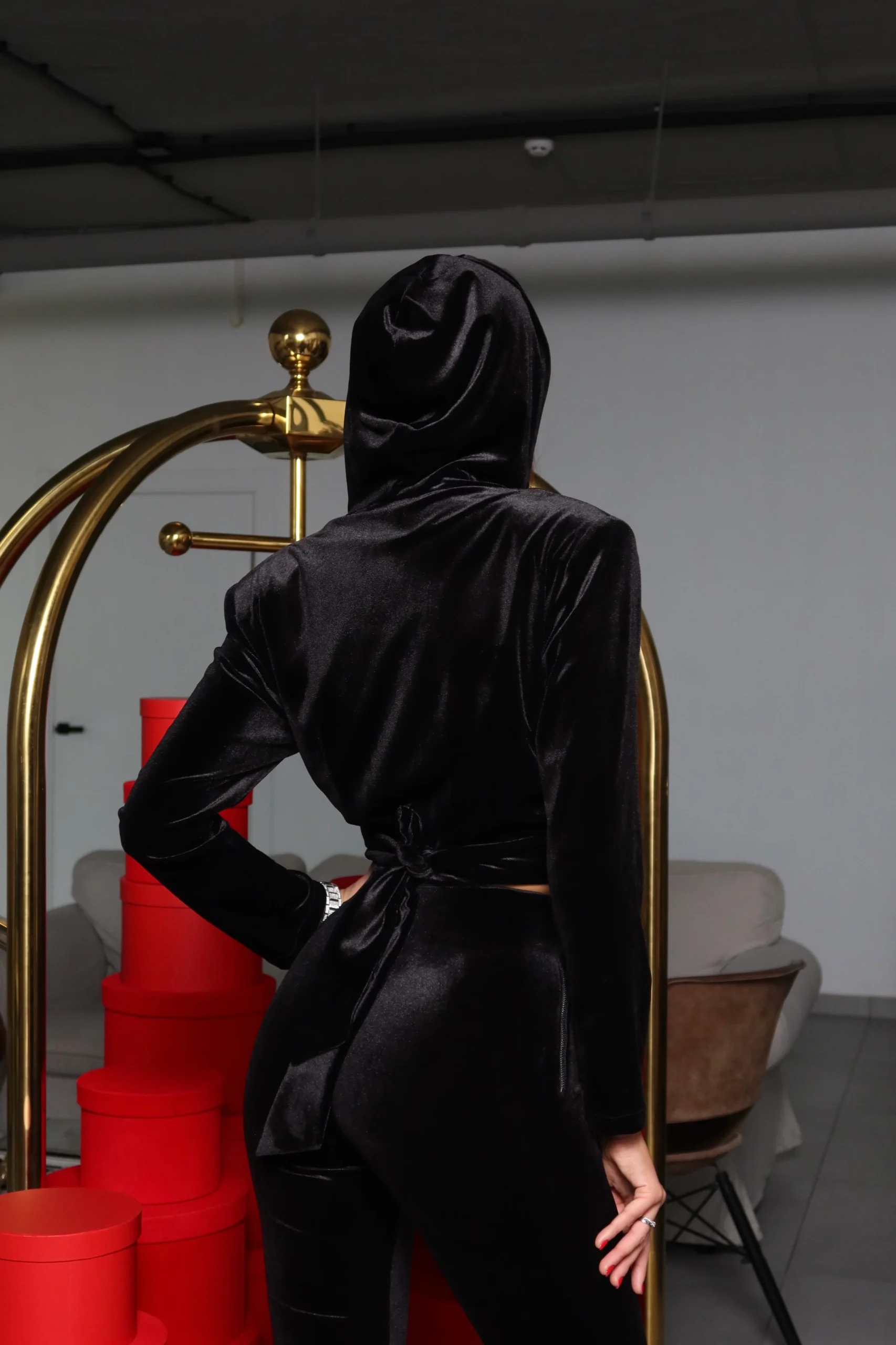 Hooded velvet top seen from the back in an interior setting by REPULO’S