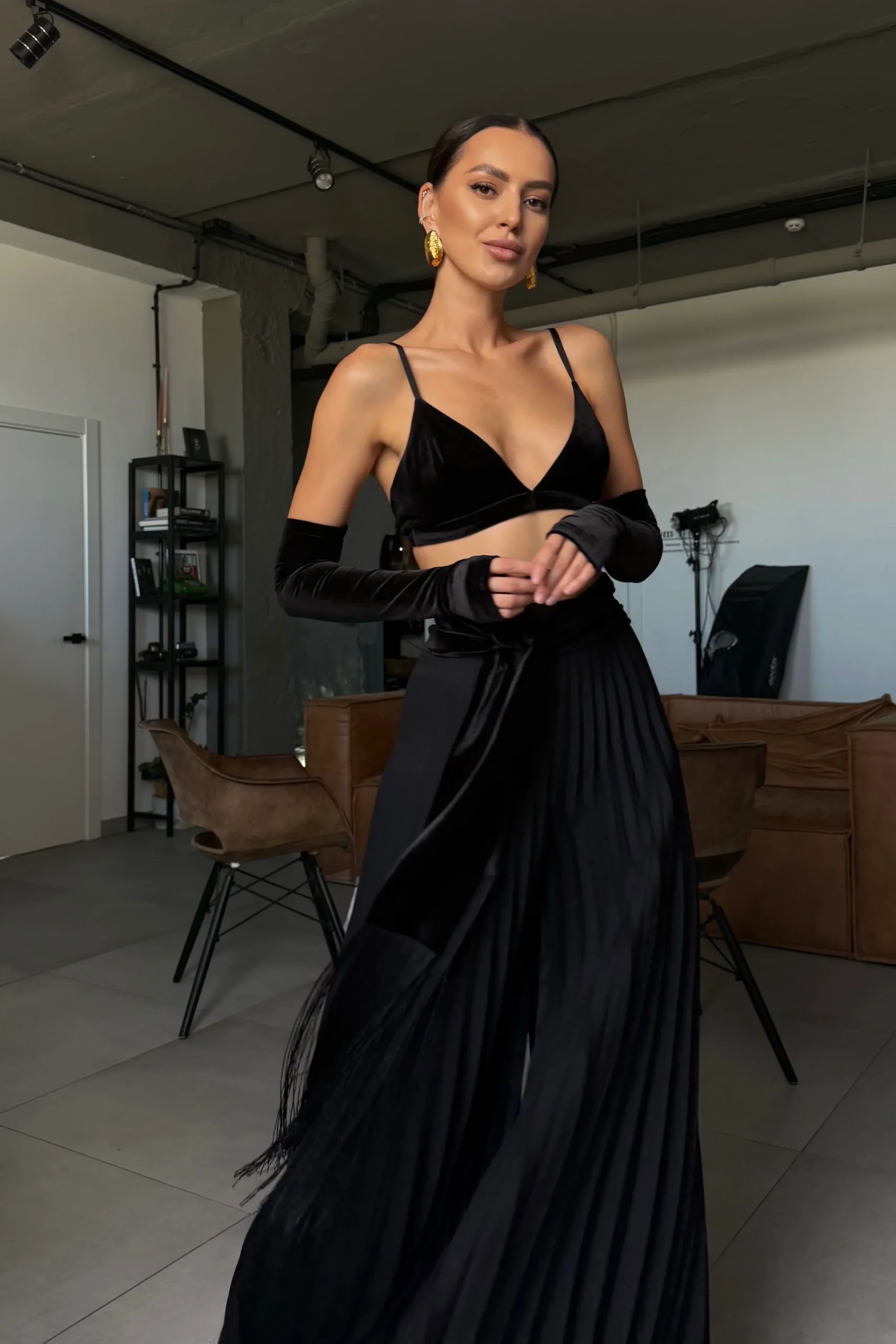 Black velvet fringe belt styled with pants and a skirt, REPULO’S