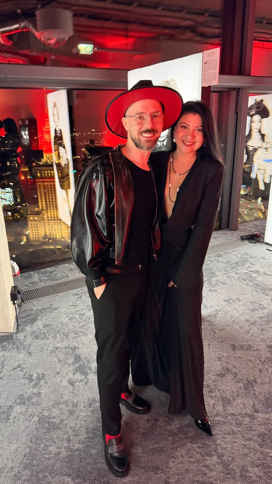 Kateryna Nechyporenko in the REPULO'S Halo gown with photographer Maksymilian Ławrynowicz at the Bad Girls premiere at Varso Tower, Palace of Culture in the background