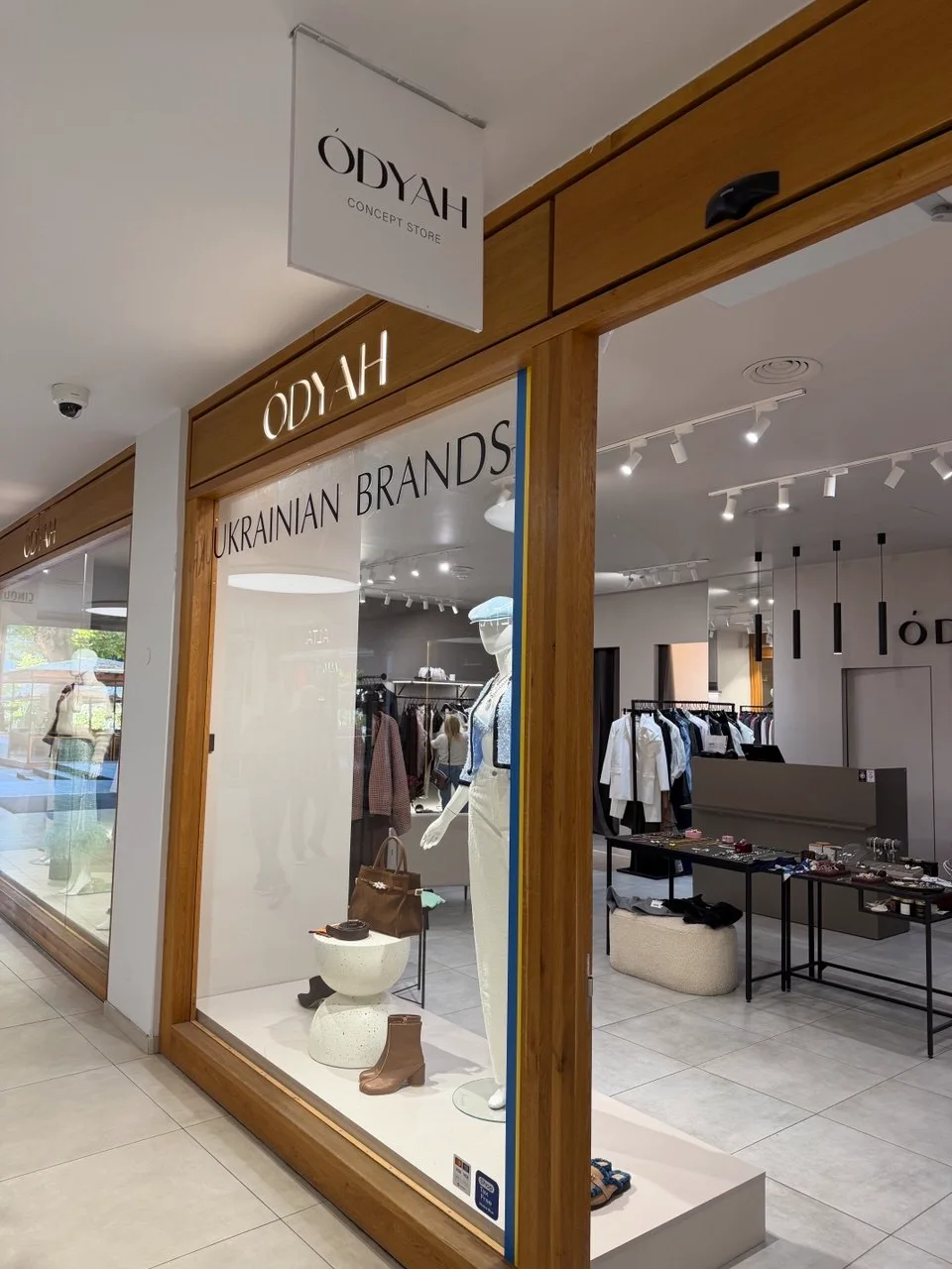 Entrance to the Ukrainian concept store ÓDYAH in Prague with its Concept Store sign and Ukrainian Brands window